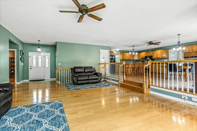 5502 Highpoint Dr, Crestwood, KY 40014 - living area featuring a ceiling fan, light wood finished floors, and a chandelier