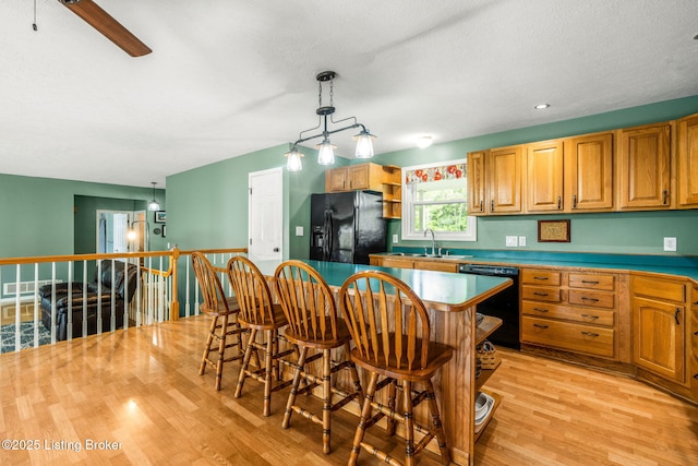 5502 Highpoint Dr, Crestwood, KY 40014 - kitchen featuring black appliances, light wood-style floors, hanging light fixtures, open shelves, and a kitchen island