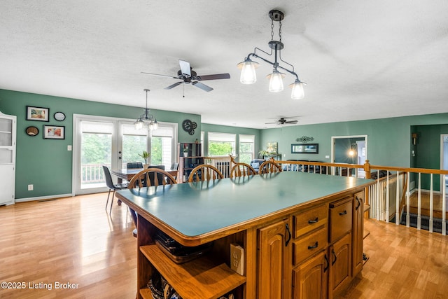5502 Highpoint Dr, Crestwood, KY 40014 - kitchen featuring ceiling fan, open shelves, a textured ceiling, a kitchen island, and light wood-type flooring