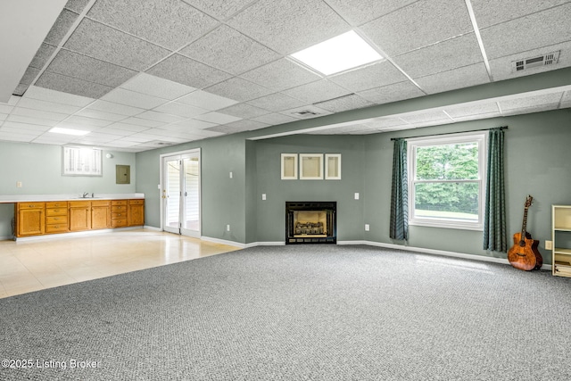 5502 Highpoint Dr, Crestwood, KY 40014 - unfurnished living room with a drop ceiling, a fireplace, plenty of natural light, and light colored carpet