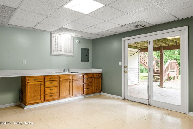 5502 Highpoint Dr, Crestwood, KY 40014 - kitchen featuring electric panel, a paneled ceiling, brown cabinets, and light countertops