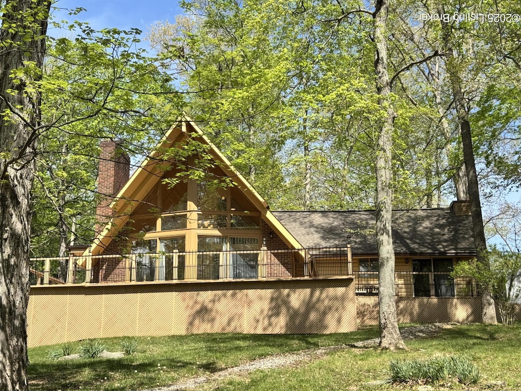 38 Brightberry St, Brandenburg, KY 40108 - rear view of property featuring a chimney, brick siding, and roof with shingles