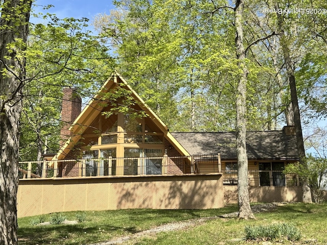 38 Brightberry St, Brandenburg, KY 40108 - rear view of property featuring a chimney, brick siding, and roof with shingles
