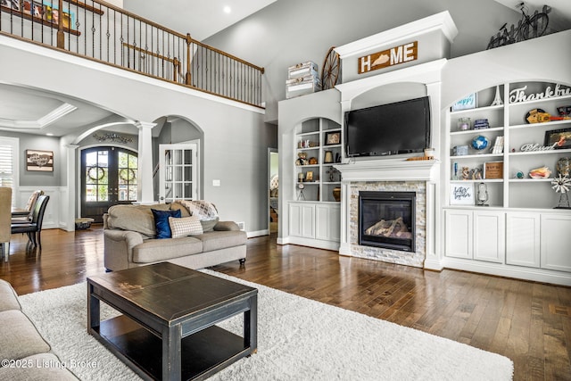 10905 Rock Valley Ct, Louisville, KY 40241 - living area featuring arched walkways, hardwood / wood-style flooring, french doors, a fireplace, and ornate columns