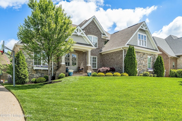 10905 Rock Valley Ct, Louisville, KY 40241 - craftsman house featuring a front lawn, french doors, brick siding, and stone siding