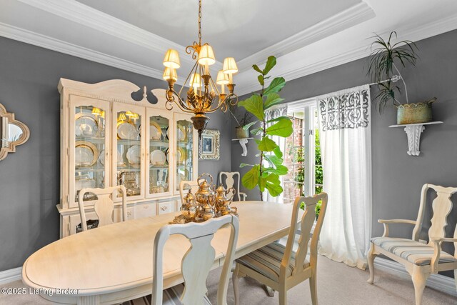 dining room with carpet flooring, crown molding, and a notable chandelier