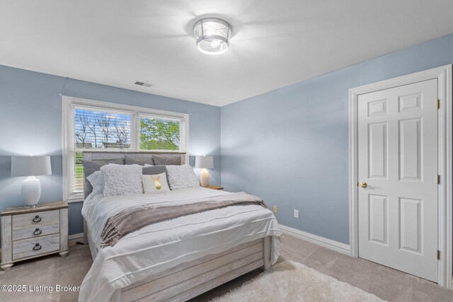 carpeted bedroom featuring visible vents and baseboards