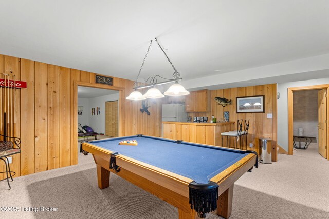 playroom with light carpet, wood walls, and billiards