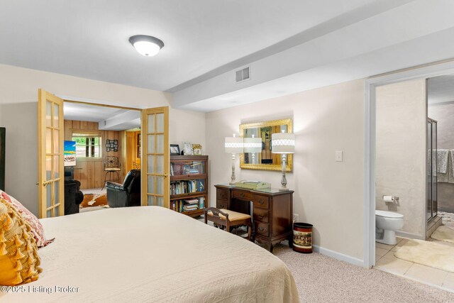 carpeted bedroom with connected bathroom, baseboards, french doors, and visible vents