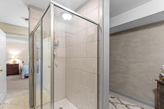 bathroom with tile patterned floors, ensuite bathroom, and a shower stall