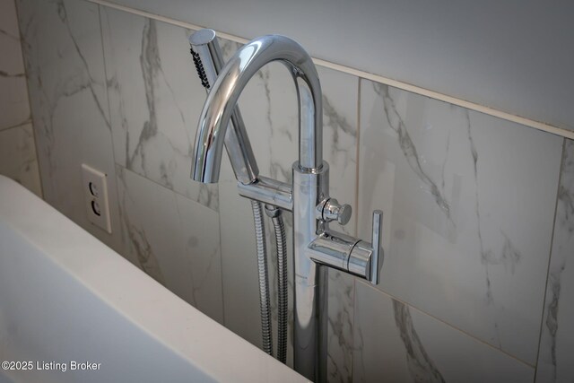 room details featuring a marble finish shower