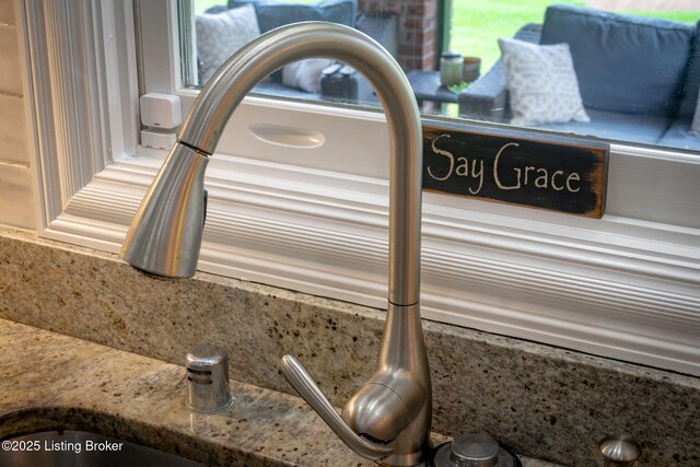 interior details featuring backsplash and a sink