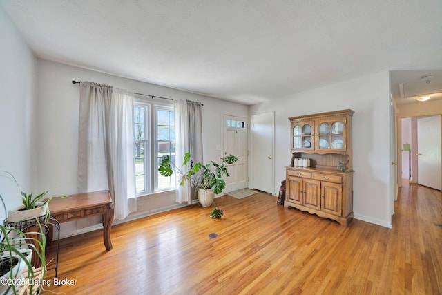 sitting room with light wood-style floors and baseboards