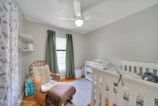 bedroom with wood finished floors and ceiling fan