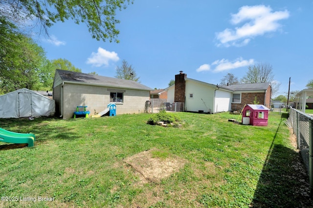 view of yard with a playground and a fenced backyard
