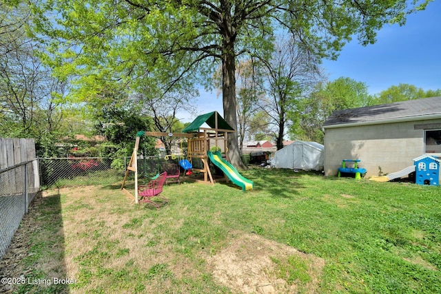 view of jungle gym with a yard and a fenced backyard