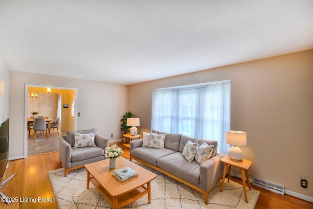 6706 Hollow Tree Rd, Louisville, KY 40228 - living area featuring baseboards, light wood-style floors, and visible vents