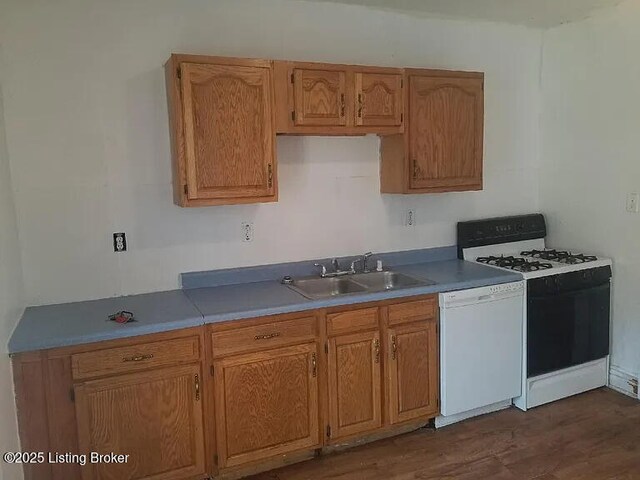 210 E Ormsby Ave, Louisville, KY 40203 - kitchen with white appliances, a sink, brown cabinets, and dark wood-style flooring