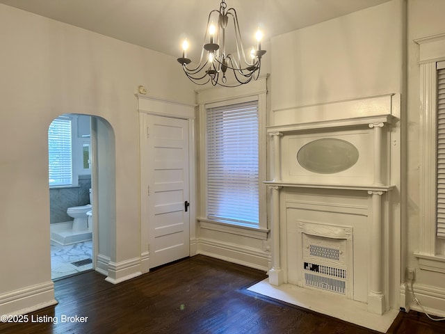 1509 S 3rd St, Louisville, KY 40208 - interior space with baseboards, a chandelier, arched walkways, and dark wood-type flooring
