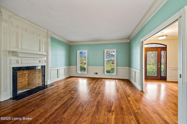 2605 Evergreen Wynde, Louisville, KY 40223 - unfurnished living room with ornamental molding, a decorative wall, a high end fireplace, wainscoting, and wood finished floors
