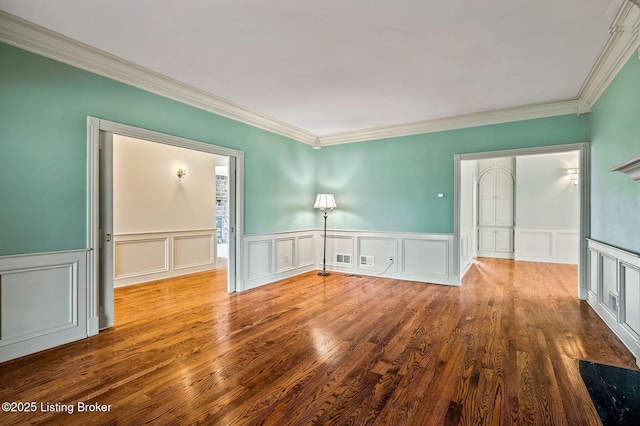 2605 Evergreen Wynde, Louisville, KY 40223 - empty room with ornamental molding, a wainscoted wall, a decorative wall, and wood finished floors