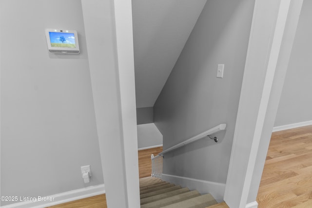 stairs featuring baseboards and wood finished floors
