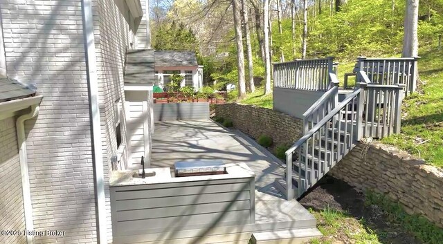 exterior details featuring brick siding and stairway