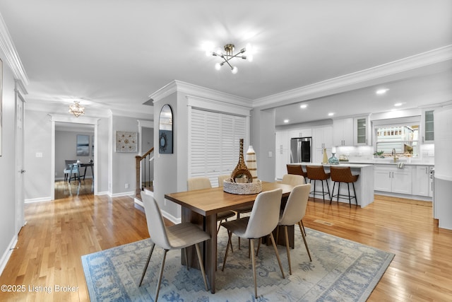 1907 Charbdin Pl, Louisville, KY 40207 - dining room featuring a chandelier, crown molding, light wood finished floors, stairway, and baseboards