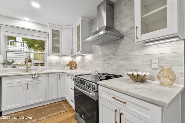 1907 Charbdin Pl, Louisville, KY 40207 - kitchen featuring wall chimney range hood, stainless steel electric range oven, a sink, decorative backsplash, and white cabinets