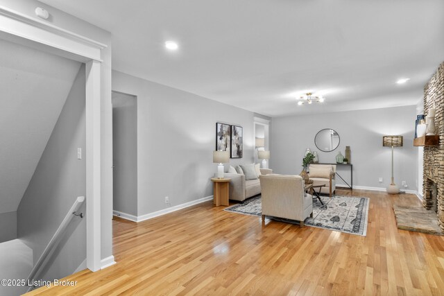 1907 Charbdin Pl, Louisville, KY 40207 - living area featuring wood finished floors, a stone fireplace, and baseboards