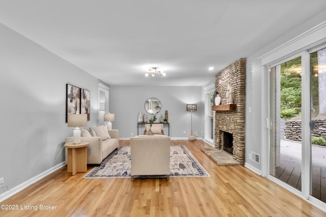 1907 Charbdin Pl, Louisville, KY 40207 - living area featuring light wood-type flooring, a stone fireplace, and baseboards