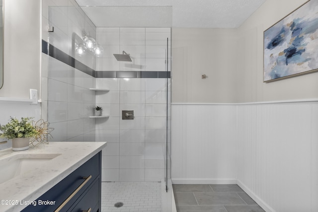 1907 Charbdin Pl, Louisville, KY 40207 - full bath featuring a tile shower, vanity, baseboards, tile patterned flooring, and a textured ceiling
