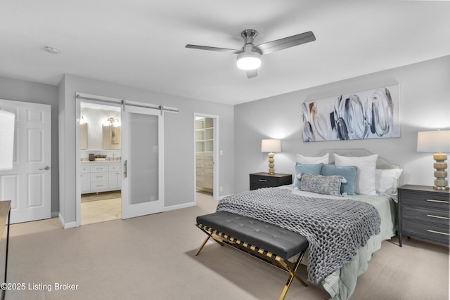 1907 Charbdin Pl, Louisville, KY 40207 - bedroom with light colored carpet, ensuite bath, a barn door, and baseboards