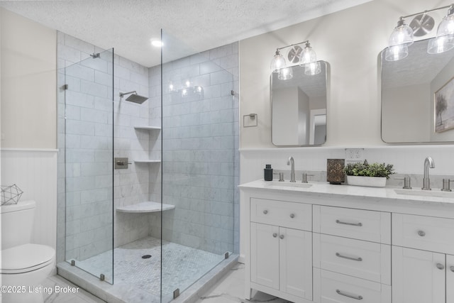 1907 Charbdin Pl, Louisville, KY 40207 - full bath featuring a textured ceiling, a shower stall, toilet, double vanity, and a wainscoted wall