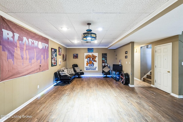 exercise room featuring wood finished floors and baseboards