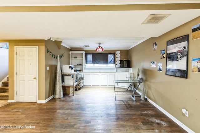 interior space featuring wood finished floors, visible vents, stairs, and baseboards