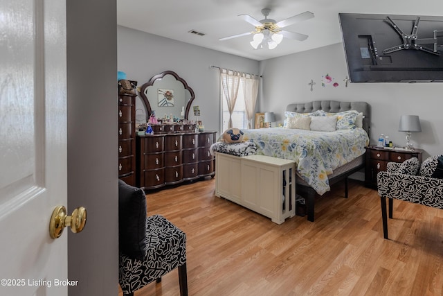 bedroom with visible vents, a ceiling fan, and light wood-style floors