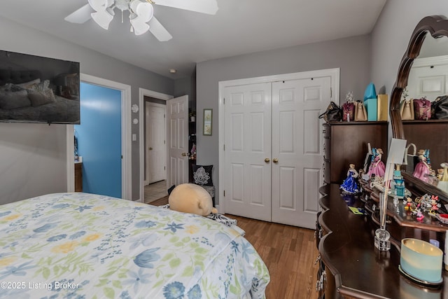 bedroom with a closet, a ceiling fan, and wood finished floors