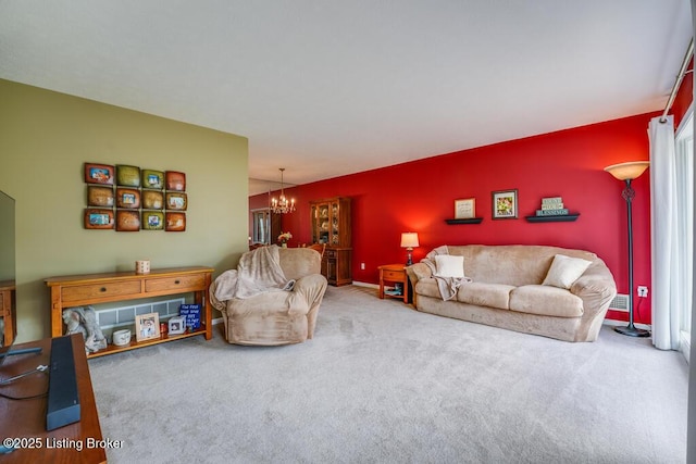 living area featuring carpet and a notable chandelier