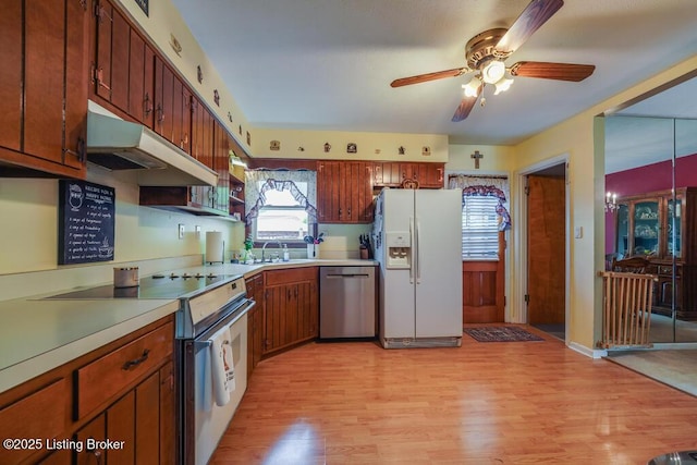 kitchen featuring white refrigerator with ice dispenser, light wood finished floors, dishwasher, range with electric cooktop, and under cabinet range hood