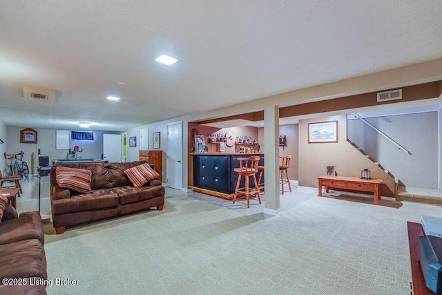 living area with stairway, a dry bar, carpet, and visible vents