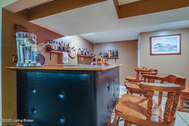 bar with baseboards and indoor bar