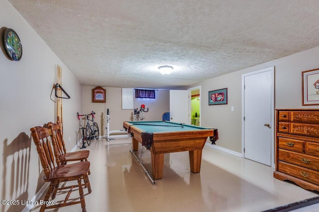 recreation room with pool table, a textured ceiling, and baseboards