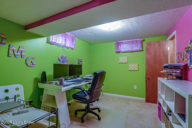 carpeted home office featuring baseboards and a textured ceiling