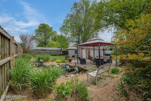 view of yard featuring a fenced backyard, a patio, a gazebo, and outdoor lounge area