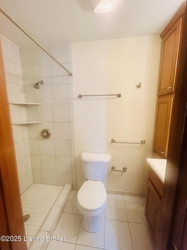 full bath with toilet, a tile shower, and vanity