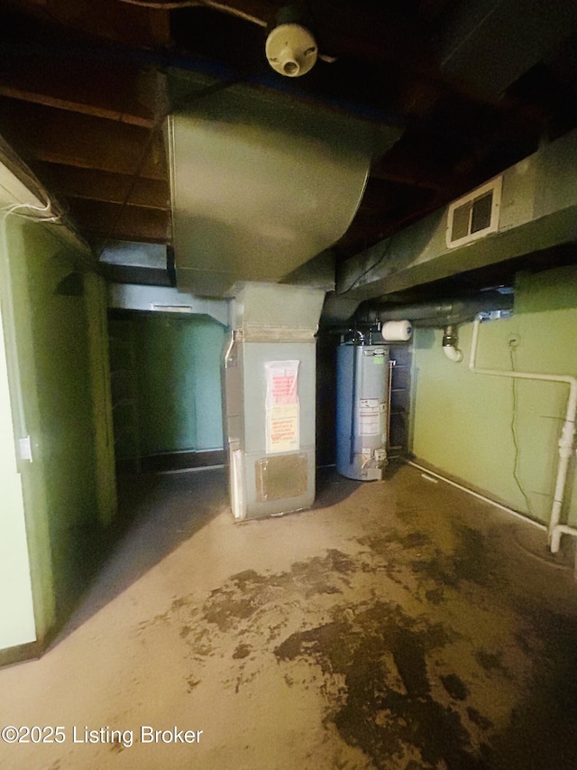 unfinished below grade area featuring water heater, visible vents, and heating unit