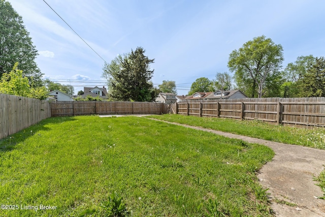 view of yard with a fenced backyard