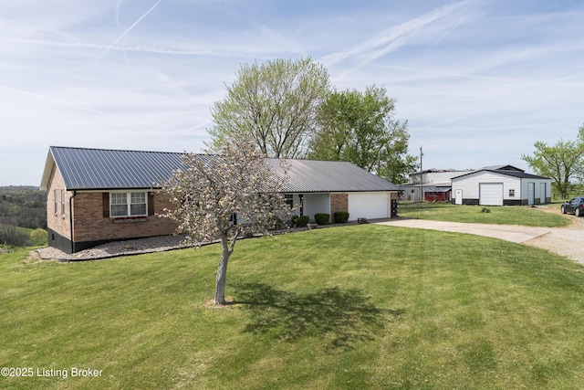 ranch-style home featuring a front yard, brick siding, metal roof, an attached garage, and driveway