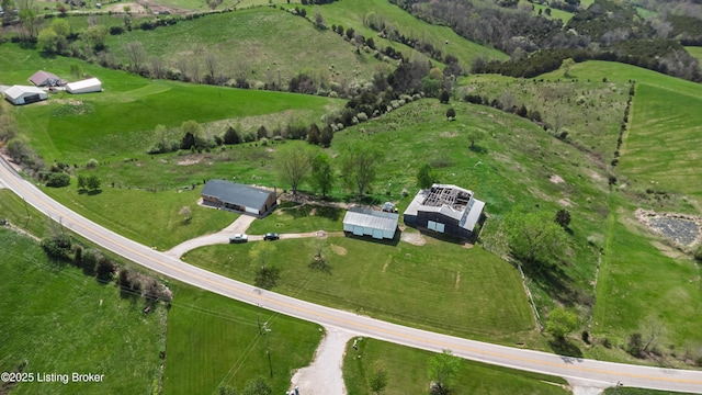 birds eye view of property with a rural view